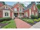 Charming brick home featuring a covered front porch and meticulously maintained landscaping at 8250 Saint Marlo Fairway Dr, Duluth, GA 30097