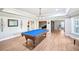 A wide game room features recessed ceilings and lighting, wood flooring, and a central pool table at 8250 Saint Marlo Fairway Dr, Duluth, GA 30097