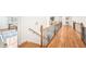 Upstairs hallway with wood flooring and wrought iron railings at 8250 Saint Marlo Fairway Dr, Duluth, GA 30097