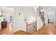 Hallway featuring hardwood floors and staircase with iron railing at 8250 Saint Marlo Fairway Dr, Duluth, GA 30097