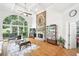 Bright living room featuring a stone fireplace, hardwood floors, and large windows at 8250 Saint Marlo Fairway Dr, Duluth, GA 30097