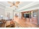 Bright living room featuring a built-in entertainment center and multiple doorways to other rooms at 8250 Saint Marlo Fairway Dr, Duluth, GA 30097