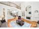 Open-concept living room with fireplace, hardwood floors, and staircase at 8250 Saint Marlo Fairway Dr, Duluth, GA 30097