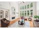 Bright living room with soaring windows, fireplace, and hardwood floors at 8250 Saint Marlo Fairway Dr, Duluth, GA 30097