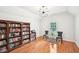 Study features a large bookshelf and a window, creating an inviting and well-lit workspace at 8250 Saint Marlo Fairway Dr, Duluth, GA 30097