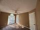 A naturally lit bedroom with a modern ceiling fan and tan walls at 1280 Waterwood Dr, Loganville, GA 30052