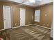 Bedroom with brown carpeting, large windows, tan walls, and a ceiling fan at 1280 Waterwood Dr, Loganville, GA 30052