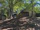Charming exterior with a porch and a shed, surrounded by lush trees and foliage at 1280 Waterwood Dr, Loganville, GA 30052