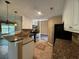 This updated kitchen features granite counters, stainless appliances, and tile flooring for easy maintenance at 1280 Waterwood Dr, Loganville, GA 30052
