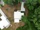 Aerial view of modern home with driveway, and unique rooftop green space surrounded by mature trees at 1604 Niskey Lake Rd, Atlanta, GA 30331