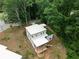 Aerial view of modern home with deck and unique rooftop green space surrounded by mature trees at 1604 Niskey Lake Rd, Atlanta, GA 30331