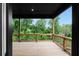 Wood deck overlooks wooded backyard with mature trees and a railing at 1604 Niskey Lake Rd, Atlanta, GA 30331