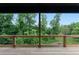 Covered deck overlooks a beautifully wooded and lush backyard at 1604 Niskey Lake Rd, Atlanta, GA 30331