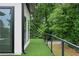 Artificial turf covered patio with steel railing and view of the woods at 1604 Niskey Lake Rd, Atlanta, GA 30331