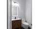 Modern bathroom features a sleek vanity with a wood cabinet and an illuminated mirror for a contemporary look at 1604 Niskey Lake Rd, Atlanta, GA 30331
