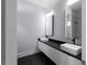 Modern bathroom featuring dual vanity, hexagon tile accents, and bright lighting at 1604 Niskey Lake Rd, Atlanta, GA 30331