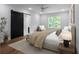 Serene bedroom with a sliding barn door to the bathroom, a plush bed, and ample natural light at 1604 Niskey Lake Rd, Atlanta, GA 30331