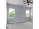 Carpeted bedroom featuring two windows and a ceiling fan at 1604 Niskey Lake Rd, Atlanta, GA 30331