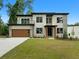 Modern home showcasing clean lines, a balcony, and a two-car garage at 1604 Niskey Lake Rd, Atlanta, GA 30331