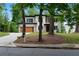 Modern two-story home with a front yard, wood garage door, and balcony at 1604 Niskey Lake Rd, Atlanta, GA 30331
