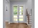 Bright foyer with hardwood floors, stairs, and natural light from the front door at 1604 Niskey Lake Rd, Atlanta, GA 30331