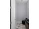 Half bathroom with marble floors, a dark vanity, an illuminated mirror, and modern fixtures at 1604 Niskey Lake Rd, Atlanta, GA 30331