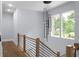 Hallway features hardwood floors, a modern light fixture, and wood and steel railing at 1604 Niskey Lake Rd, Atlanta, GA 30331