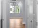 Bright hallway with natural light, modern lighting and hardwood floors at 1604 Niskey Lake Rd, Atlanta, GA 30331