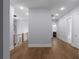 Bright hallway features hardwood floors, modern lighting, and entryways to other rooms at 1604 Niskey Lake Rd, Atlanta, GA 30331