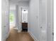 Upstairs hallway featuring wood floors with entrances to a bedroom and bathroom at 1604 Niskey Lake Rd, Atlanta, GA 30331