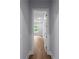 Hallway view with hardwood floors leading to a room with natural light at 1604 Niskey Lake Rd, Atlanta, GA 30331