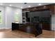 Modern kitchen featuring a center island with black marble countertops, stainless steel appliances, and an adjacent outdoor space at 1604 Niskey Lake Rd, Atlanta, GA 30331