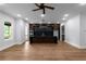 Open-concept kitchen featuring wood floors, large center island with black marble countertops, and stainless steel appliances at 1604 Niskey Lake Rd, Atlanta, GA 30331