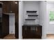 Wet bar features a wine cooler, floating shelves, and black counter at 1604 Niskey Lake Rd, Atlanta, GA 30331