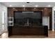 Modern kitchen featuring black marble countertops, a large center island, and stainless steel double ovens at 1604 Niskey Lake Rd, Atlanta, GA 30331