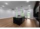 Modern kitchen with black marble countertops, center island, stainless steel appliances, and hardwood floors at 1604 Niskey Lake Rd, Atlanta, GA 30331