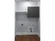 Functional laundry room features hardwood floors and gray cabinets to store laundry supplies at 1604 Niskey Lake Rd, Atlanta, GA 30331