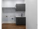 Laundry room with cabinetry, countertop, sink, and wood flooring at 1604 Niskey Lake Rd, Atlanta, GA 30331