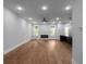 Bright living room with hardwood floors, ceiling fan, a modern fireplace, and large windows offering natural light at 1604 Niskey Lake Rd, Atlanta, GA 30331