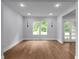 Bright, minimalist living room with hardwood floors, recessed lights, and large windows at 1604 Niskey Lake Rd, Atlanta, GA 30331