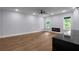 Bright living room with hardwood floors, a modern fireplace, a ceiling fan, and adjacent kitchen featuring marble countertops at 1604 Niskey Lake Rd, Atlanta, GA 30331