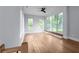Bright living room with hardwood floors, large windows, and modern ceiling fan at 1604 Niskey Lake Rd, Atlanta, GA 30331