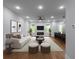 Open living area featuring modern furnishings, fireplace, and access to kitchen bar seating creates a seamless flow at 1604 Niskey Lake Rd, Atlanta, GA 30331