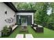 Inviting outdoor patio with comfortable seating, artificial turf, and lush greenery, perfect for relaxation at 1604 Niskey Lake Rd, Atlanta, GA 30331