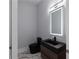 Modern powder room featuring black fixtures and stylish marble tile flooring at 1604 Niskey Lake Rd, Atlanta, GA 30331