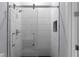 Contemporary shower with vertical tiling and sliding glass door at 1604 Niskey Lake Rd, Atlanta, GA 30331