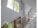 Open staircase with wood railing, black metal balusters, and natural light from nearby windows at 1604 Niskey Lake Rd, Atlanta, GA 30331
