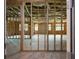 View of the unfinished room with a wooden frame, insulation, and several windows at 1604 Niskey Lake Rd, Atlanta, GA 30331