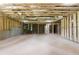Huge unfinished room with concrete walls, framing, insulation, and a door at 1604 Niskey Lake Rd, Atlanta, GA 30331