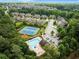 Aerial shot of community amenities featuring a pool, tennis courts and well manicured lawns in a beautiful neighborhood at 3317 Sweetleaf Ln, Buford, GA 30519